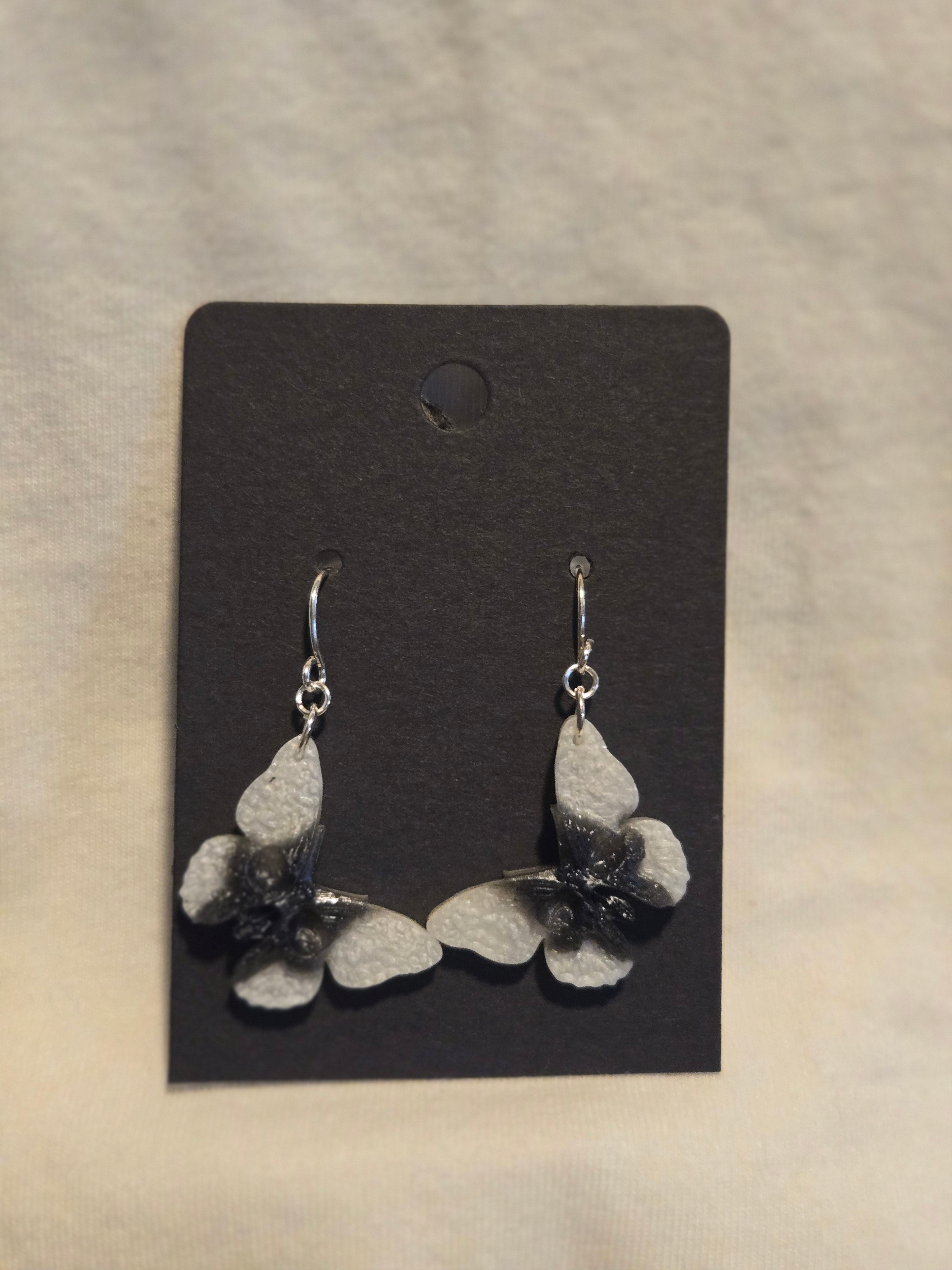Small skull moth dangle earrings